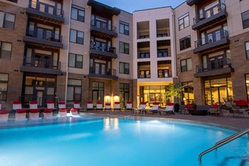 A swimming pool in front of an apartment building